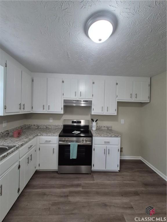 115 Big Oak Cir, Athens, GA 30605 - kitchen featuring stainless steel range with electric stovetop, under cabinet range hood, white cabinetry, a textured ceiling, and light countertops