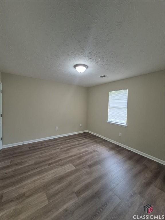 115 Big Oak Cir, Athens, GA 30605 - spare room featuring baseboards, dark wood-type flooring, and a textured ceiling