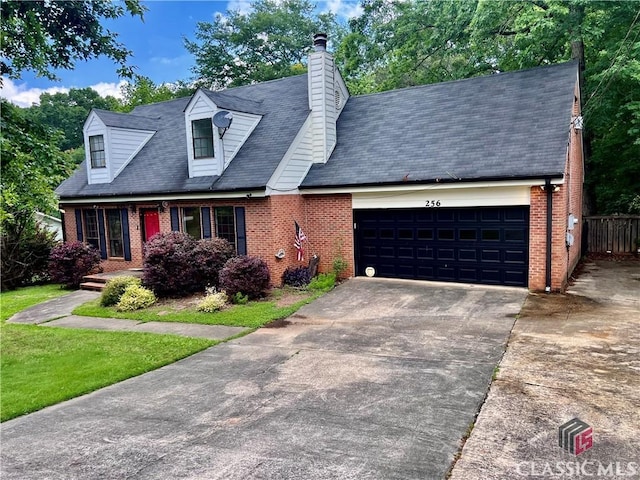 256 Cherokee Rdg, Athens, GA 30606 - cape cod-style house featuring brick siding, a garage, concrete driveway, and a chimney