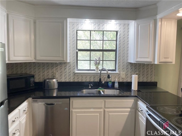 256 Cherokee Rdg, Athens, GA 30606 - kitchen featuring stainless steel appliances, a sink, white cabinets, and dark countertops