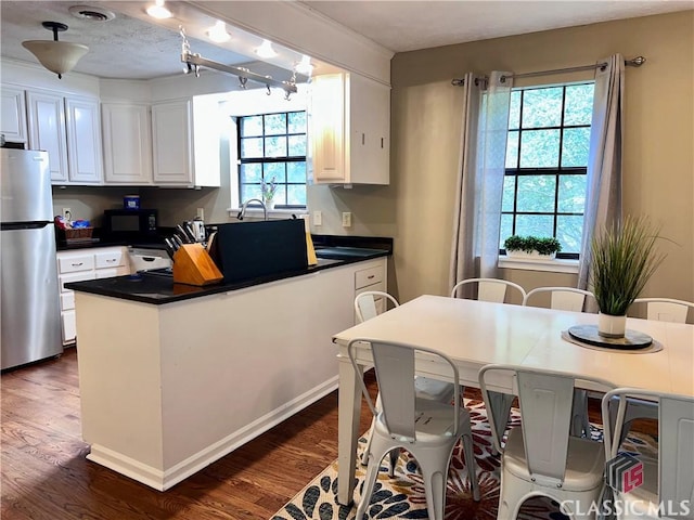 256 Cherokee Rdg, Athens, GA 30606 - kitchen with freestanding refrigerator, black microwave, dark wood finished floors, and dark countertops