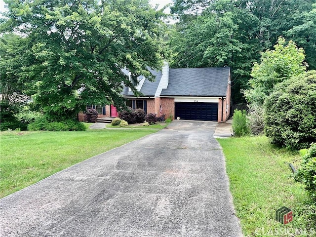256 Cherokee Rdg, Athens, GA 30606 - view of front of home featuring brick siding, driveway, a garage, a front yard, and a chimney