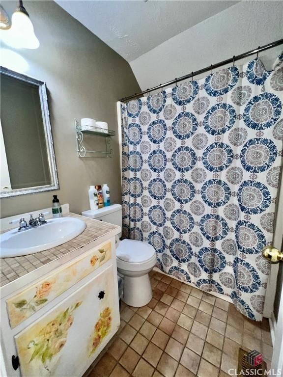 256 Cherokee Rdg, Athens, GA 30606 - bathroom with toilet, vanity, curtained shower, tile patterned flooring, and vaulted ceiling