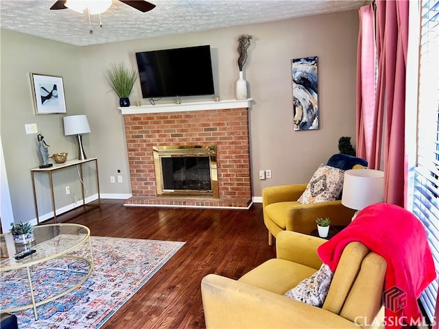 256 Cherokee Rdg, Athens, GA 30606 - living room featuring ceiling fan, a textured ceiling, wood finished floors, baseboards, and a fireplace