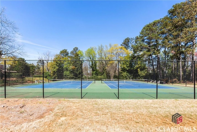 view of tennis court with fence