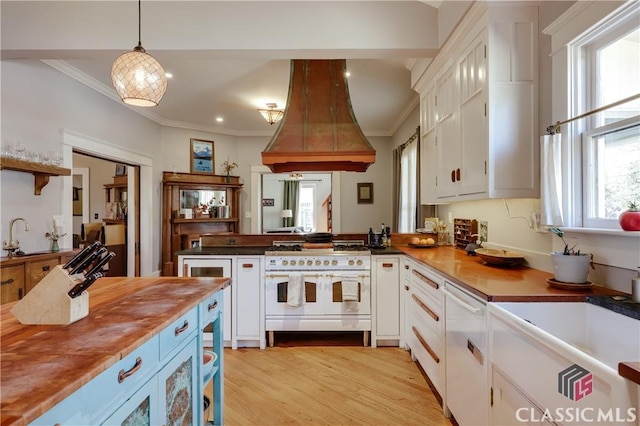 kitchen featuring white appliances, custom range hood, white cabinetry, ornamental molding, and recessed lighting