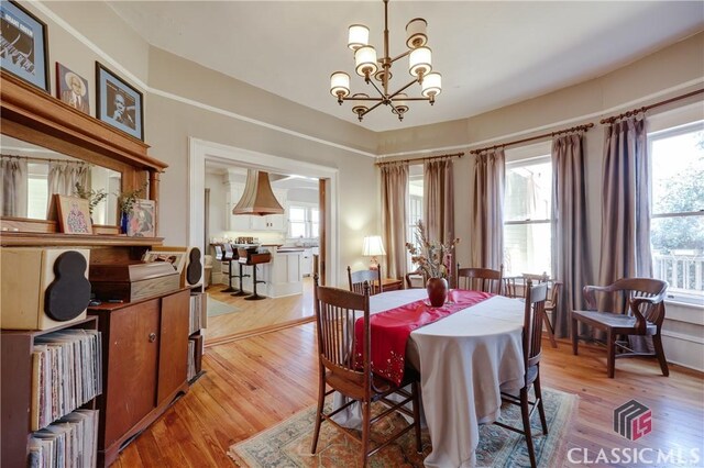 dining area with a chandelier and light wood-type flooring