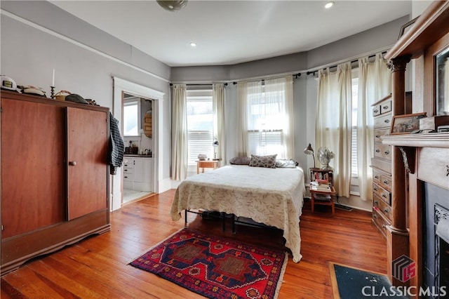 bedroom featuring wood finished floors and recessed lighting