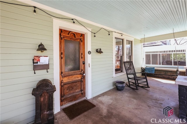 view of exterior entry featuring a porch