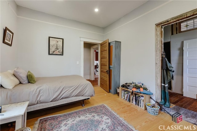 bedroom with wood finished floors and recessed lighting