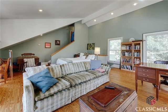 living area featuring vaulted ceiling, light wood-type flooring, and recessed lighting