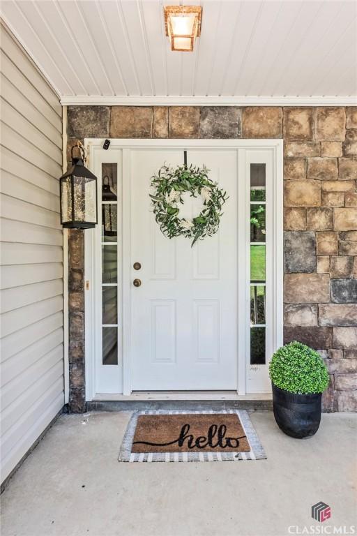 property entrance featuring stone siding