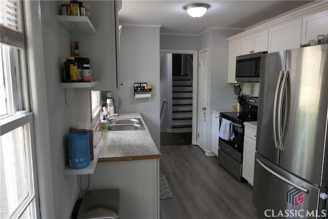 348 Jefferson River Rd, Athens, GA 30607 - kitchen with appliances with stainless steel finishes, a sink, open shelves, ornamental molding, and wood finished floors