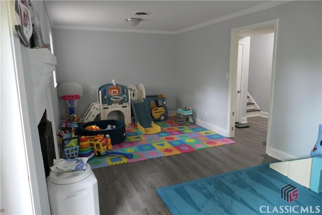 348 Jefferson River Rd, Athens, GA 30607 - playroom with wood finished floors, ornamental molding, baseboards, and a fireplace