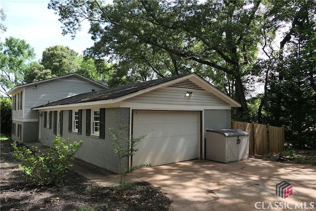 348 Jefferson River Rd, Athens, GA 30607 - view of side of home featuring concrete driveway, fence, and brick siding
