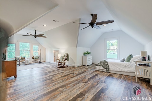 bedroom with lofted ceiling, multiple windows, wood finished floors, baseboards, and recessed lighting