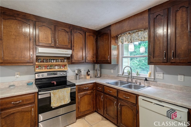 kitchen with stainless steel range with electric cooktop, dishwasher, under cabinet range hood, a sink, and light countertops