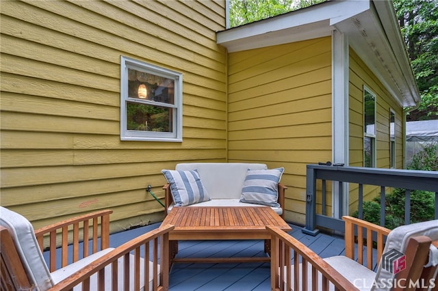 wooden terrace featuring outdoor lounge area