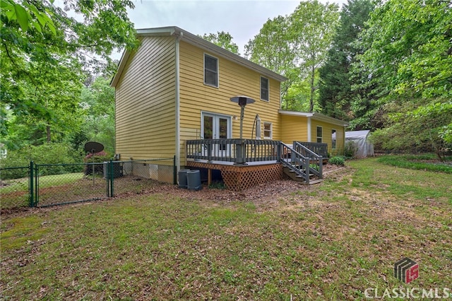 back of house featuring crawl space, a wooden deck, a gate, an outbuilding, and french doors
