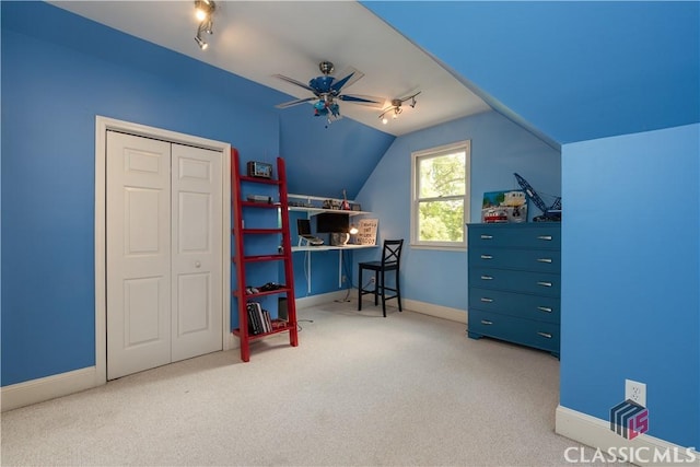 carpeted bedroom featuring track lighting, baseboards, vaulted ceiling, a closet, and a ceiling fan