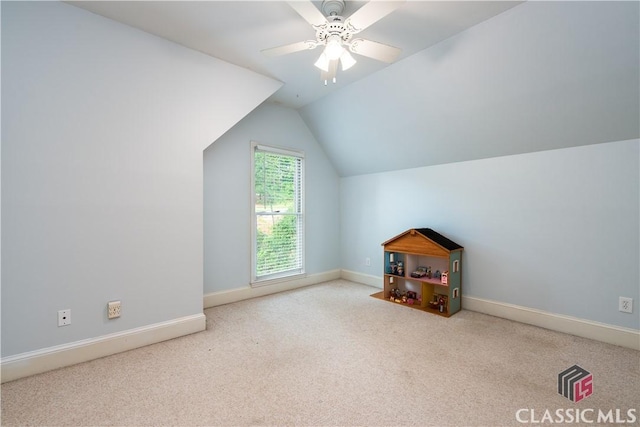 additional living space with carpet floors, lofted ceiling, ceiling fan, and baseboards