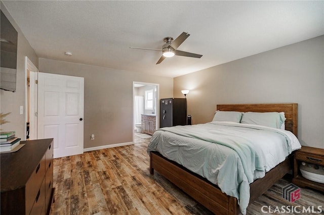 2100 New Hope Church Rd, Comer, GA 30629 - bedroom featuring light wood-style flooring, baseboards, ensuite bathroom, and ceiling fan