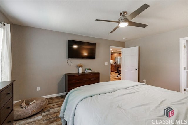 2100 New Hope Church Rd, Comer, GA 30629 - bedroom featuring wood finished floors, baseboards, stainless steel fridge, and a ceiling fan