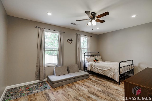 2100 New Hope Church Rd, Comer, GA 30629 - bedroom with multiple windows, wood finished floors, baseboards, recessed lighting, and ceiling fan