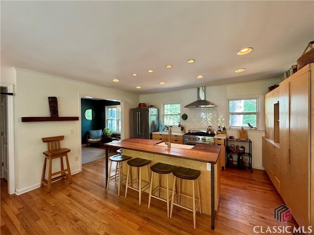 160 Gran Ellen Dr, Athens, GA 30606 - kitchen with stainless steel appliances, wall chimney exhaust hood, butcher block countertops, a sink, and recessed lighting