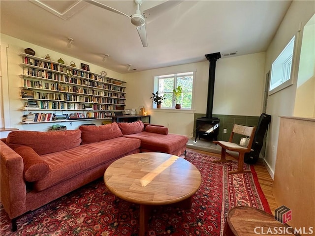 160 Gran Ellen Dr, Athens, GA 30606 - sitting room featuring a ceiling fan, a wood stove, and wood finished floors