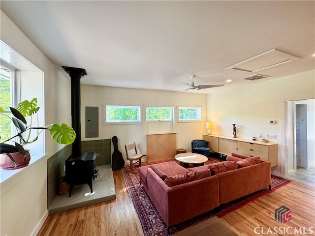 160 Gran Ellen Dr, Athens, GA 30606 - living room with a wood stove, electric panel, wood finished floors, baseboards, and a ceiling fan