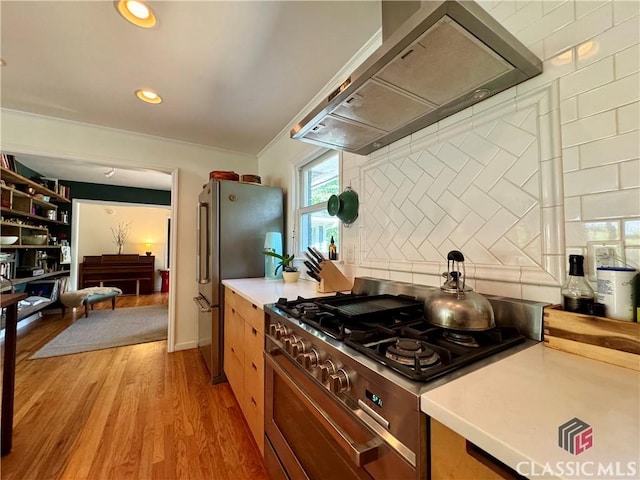 160 Gran Ellen Dr, Athens, GA 30606 - kitchen featuring extractor fan, appliances with stainless steel finishes, backsplash, light wood-style flooring, and light countertops