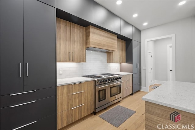 1895 Vintage Pl, Watkinsville, GA 30677 - kitchen with double oven range, modern cabinets, custom range hood, light wood-style flooring, and recessed lighting