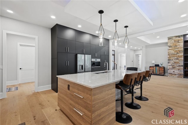 1895 Vintage Pl, Watkinsville, GA 30677 - kitchen with stainless steel fridge with ice dispenser, a sink, dark cabinets, recessed lighting, and light wood finished floors