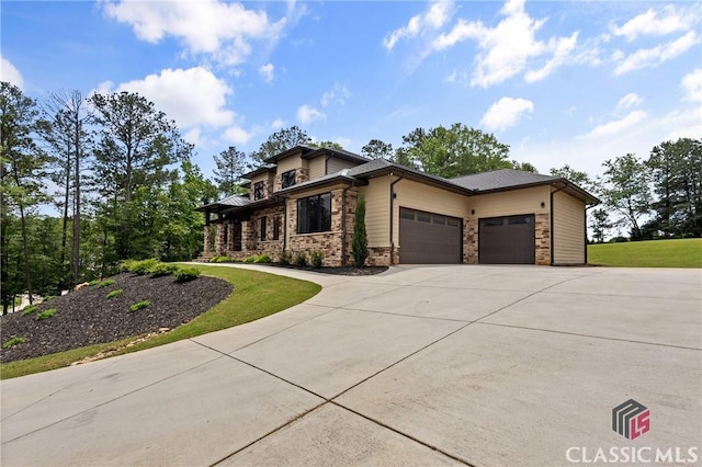 1895 Vintage Pl, Watkinsville, GA 30677 - view of front of property featuring concrete driveway, a garage, stone siding, and a front lawn