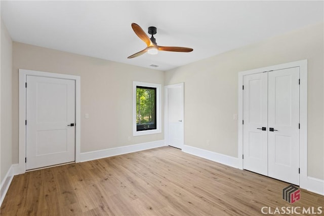 1895 Vintage Pl, Watkinsville, GA 30677 - unfurnished bedroom featuring light wood-style flooring, baseboards, and a ceiling fan