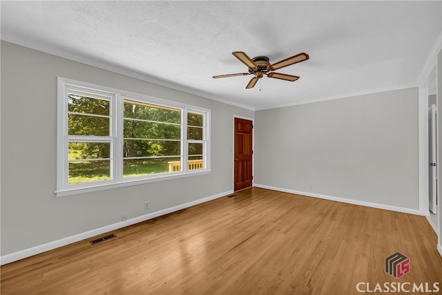 1119 John W Breedlove Rd, Monroe, GA 30656 - spare room featuring light wood-style flooring, ceiling fan, baseboards, and crown molding