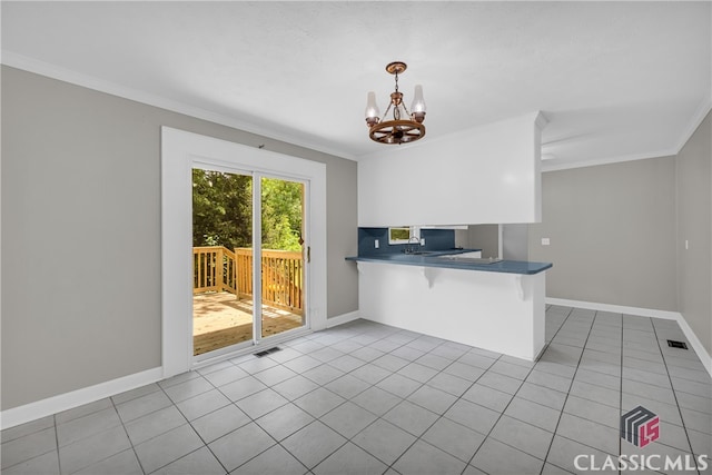 1119 John W Breedlove Rd, Monroe, GA 30656 - kitchen featuring ornamental molding, a chandelier, tile patterned flooring, dark countertops, and baseboards