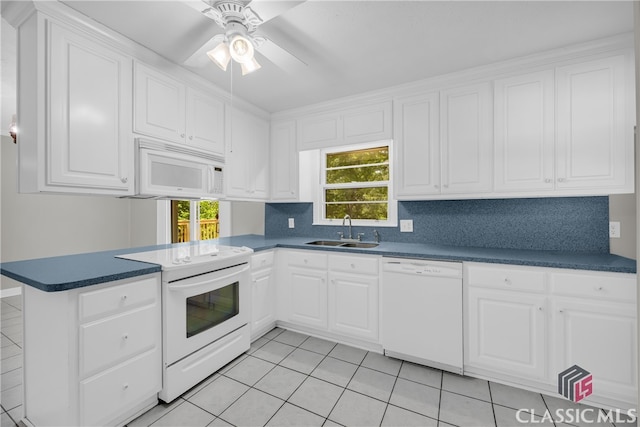 1119 John W Breedlove Rd, Monroe, GA 30656 - kitchen with white appliances, a sink, a peninsula, white cabinets, and dark countertops