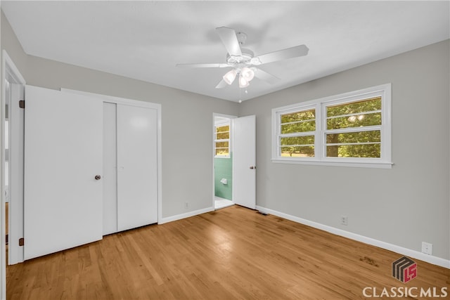 1119 John W Breedlove Rd, Monroe, GA 30656 - unfurnished bedroom featuring baseboards, light wood finished floors, a closet, and a ceiling fan