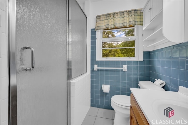 1119 John W Breedlove Rd, Monroe, GA 30656 - full bath with tile patterned flooring, a shower stall, toilet, vanity, and tile walls