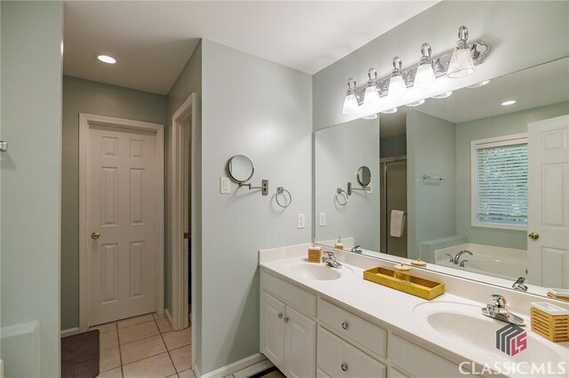 115 Crystal Creek Ct, Hull, GA 30646 - full bathroom with tile patterned floors, a stall shower, a garden tub, double vanity, and baseboards