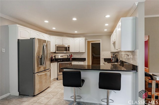 115 Crystal Creek Ct, Hull, GA 30646 - kitchen featuring stainless steel appliances, a peninsula, a sink, ornamental molding, and decorative backsplash