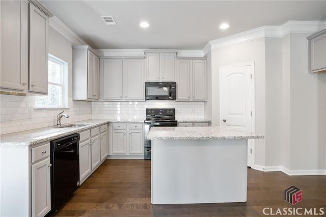 174 Water Oak Way, Crawford, GA 30630 - kitchen with black appliances, a sink, light stone counters, backsplash, and dark wood finished floors