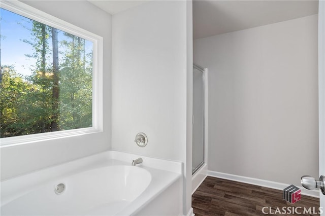 174 Water Oak Way, Crawford, GA 30630 - full bathroom with a bath, a stall shower, wood finished floors, and baseboards