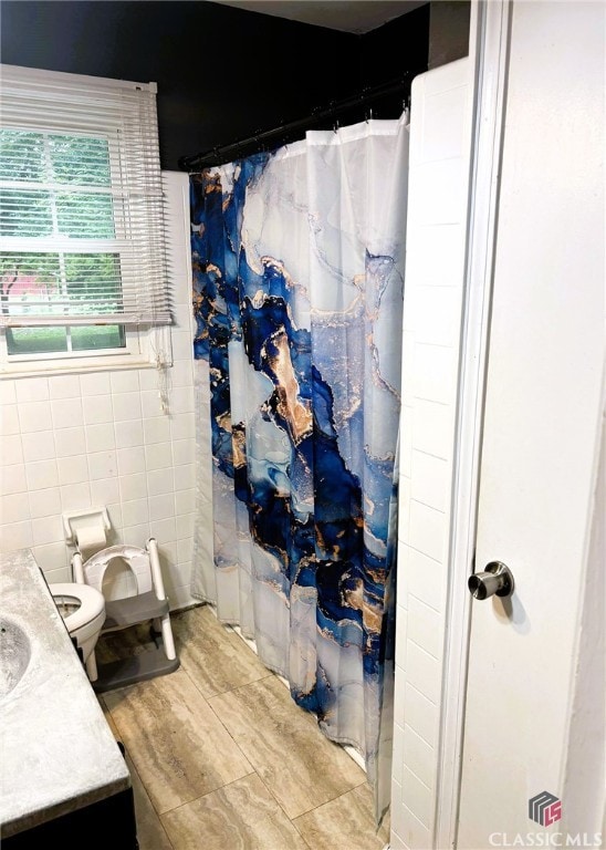 75 Gunnell Rd, Comer, GA 30629 - bathroom featuring tile walls, vanity, toilet, and curtained shower