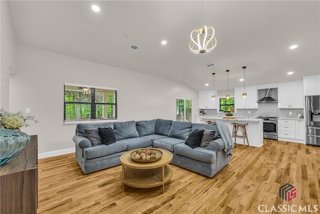 3920 Old Lexington Rd, Athens, GA 30605 - living room featuring light wood-style flooring, recessed lighting, a chandelier, baseboards, and lofted ceiling