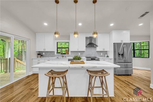 3920 Old Lexington Rd, Athens, GA 30605 - kitchen featuring stainless steel appliances, wall chimney range hood, a sink, a center island, and tasteful backsplash