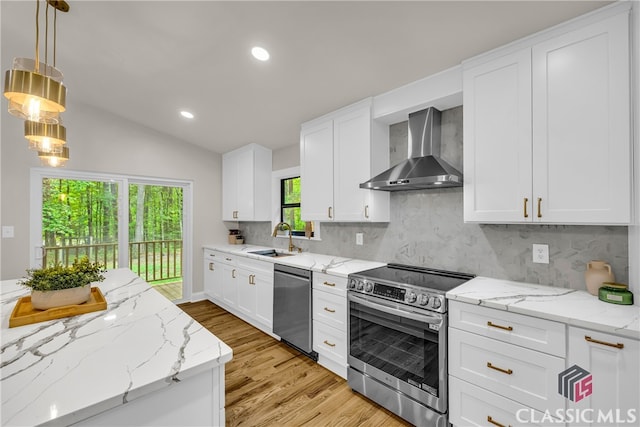 3920 Old Lexington Rd, Athens, GA 30605 - kitchen featuring appliances with stainless steel finishes, wall chimney range hood, a sink, light wood finished floors, and backsplash