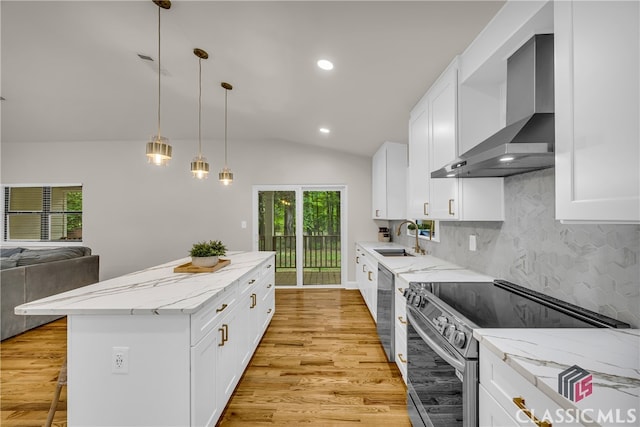 3920 Old Lexington Rd, Athens, GA 30605 - kitchen with stainless steel appliances, wall chimney exhaust hood, a sink, a kitchen island, and light wood-type flooring